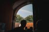 Photo of visitors walking through an open gate with a rainbow in the sky at Gut Bennigsen estate grounds in Bennigsen, Germany.