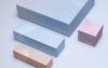 Four Covey Skincare packaging design products laid flat in studio lighting against a soft blue background