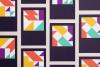 a grid of cards with geometric patterns on a dark purple background. Each card features a bold, abstract design made up of triangles, rectangles, and other shapes in vibrant colors, including orange, yellow, purple, green, and white